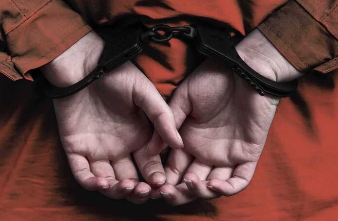 shutterstock_795931975 person in handcuffs with hands behind back