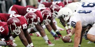 American football players lined up at the line of scrimmage