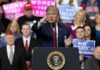 Port Huron Eruption – ‘Paid’ Heckler Ousted Donald Trump speaking at a rally podium, pointing toward the audience