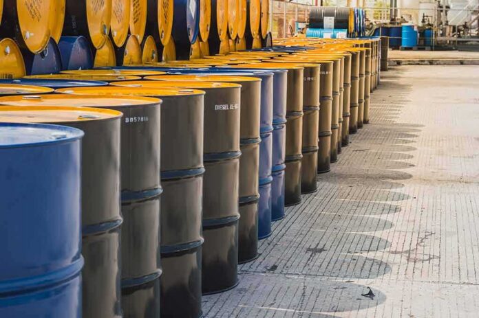 shutterstock_1082741726 Rows of industrial metal barrels with yellow lids