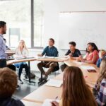 Higher Education Just Got a $3 Billion Surprise Teacher leading a discussion with students in a classroom