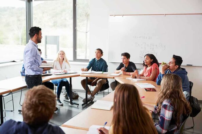 shutterstock_1127431418 Teacher leading a discussion with students in a classroom