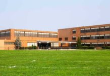 Brick school building with large windows and front entrance