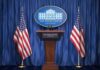 Concert Quip Triggers Brutal White House Blast White House press podium with microphones and two American flags