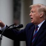 Export Ban Threat – Will Europe Blink? Donald Trump speaking at a podium and pointing