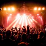 No-Politics Claim Meets Brutal Reality concert crowd under bright stage lights