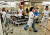 Hospital emergency room with staff moving patients on stretchers