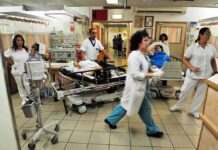 Hospital emergency room with staff moving patients on stretchers