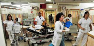 Hospital emergency room with staff moving patients on stretchers