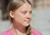 young woman with braid looking to the side outdoors