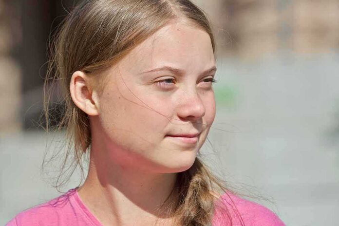 young woman with braid looking to the side outdoors