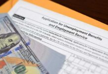 Unemployment benefits application with cash and envelope