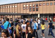 Students gathered outside a school building entrance