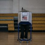 White House Briefing Plot? Voting Test Mystery Voter at a polling booth in a gymnasium