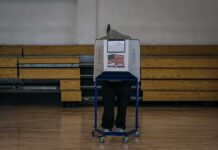 White House Briefing Plot? Voting Test Mystery Voter at a polling booth in a gymnasium