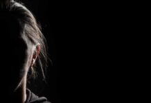 silhouette of a person's face in low-key lighting