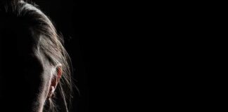 silhouette of a person's face in low-key lighting