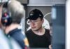 Congress Circles Musk – What’s The Real Play? Elon Musk wearing a black cap in a crowded indoor setting