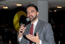 Shots Fired – NYC Takes On Feds Zohran Mamdani speaking into a microphone