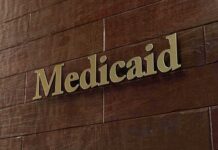 Medicaid sign on a brown wooden wall