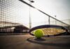 A Champion Speaks Out After an Ugly Backlash Tennis racket and ball on a court near the net