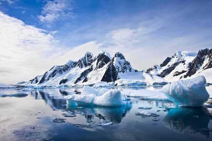 shutterstock_70478968 Icebergs floating before snow-covered mountains under a bright sky
